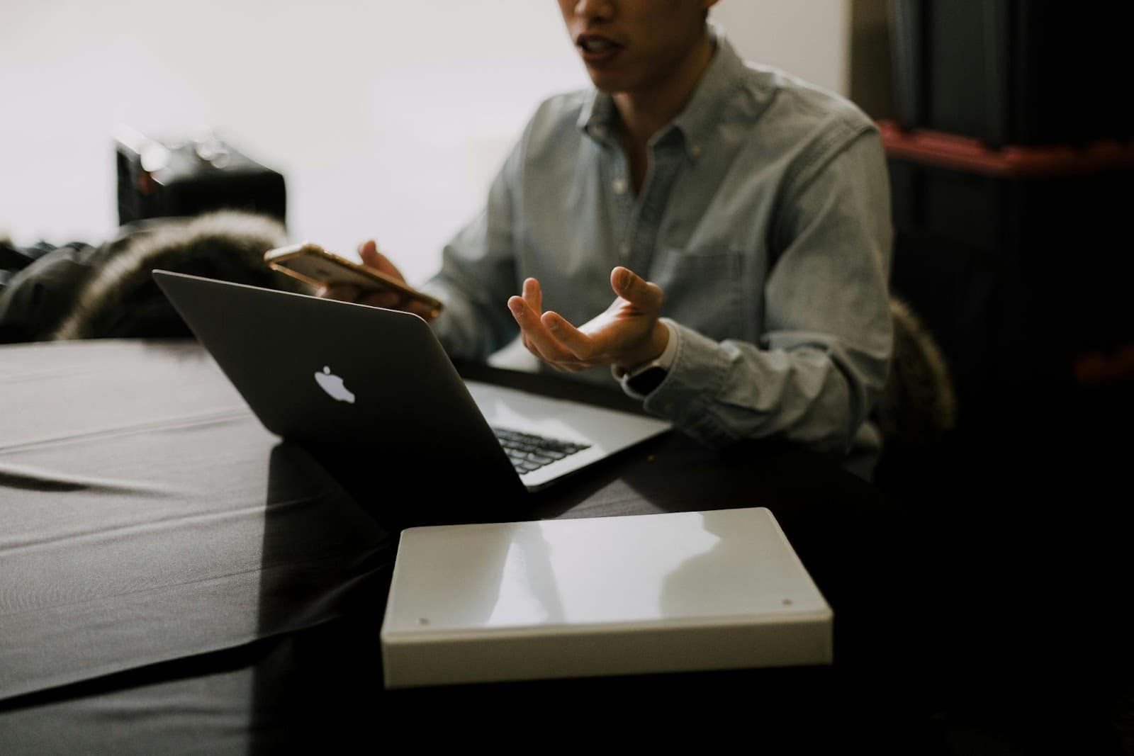 a person pointing at a laptop